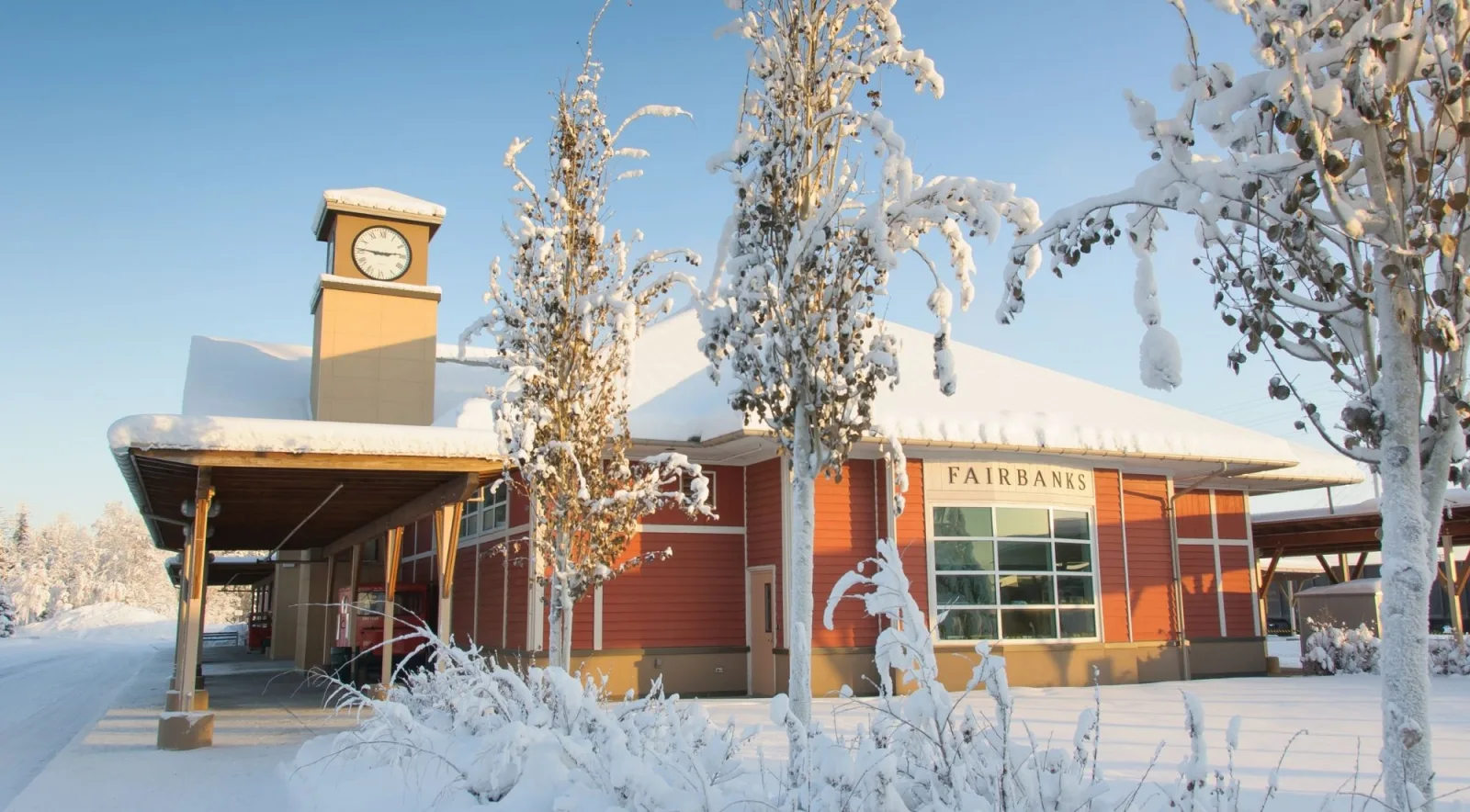 Fairbanks railroad depot with a clock tower and frost-covered birch trees