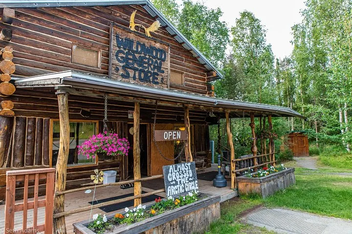 Porch of the Wildwood General Store with its Almost Crossed the Arctic Circle sign