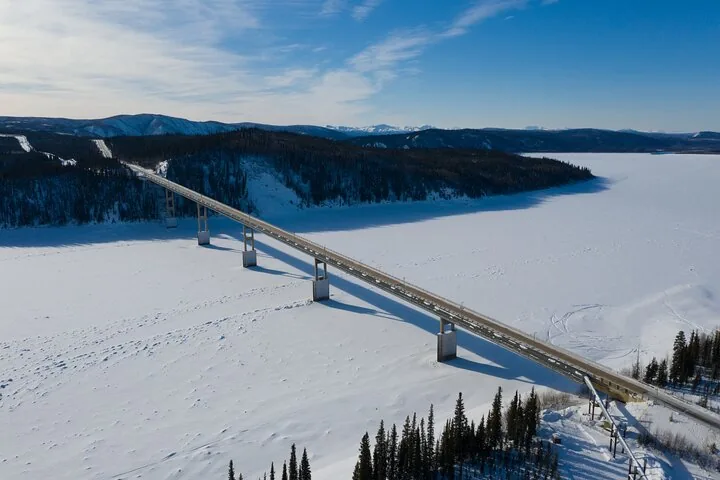 Aerial view of the Yukon River bridge crossing the frozen river in winter